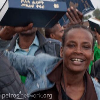 Smiling man holding box above head